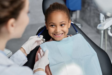 Happy child at first dental visit with pediatric dentist at Galleon Way Dental
