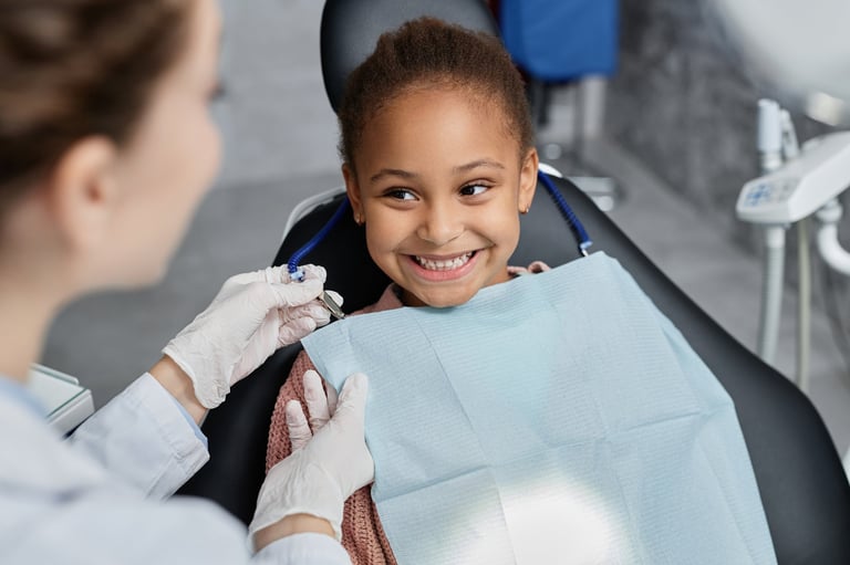 Happy little girl at her first dental visit with pediatric dentist at Galleon Way Dental