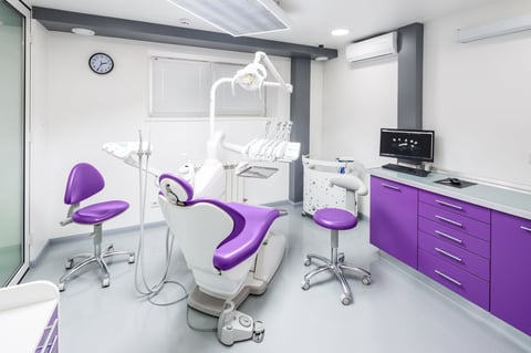 Modern dental office with purple chairs and advanced tools